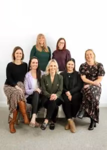 Women smiling in board photo